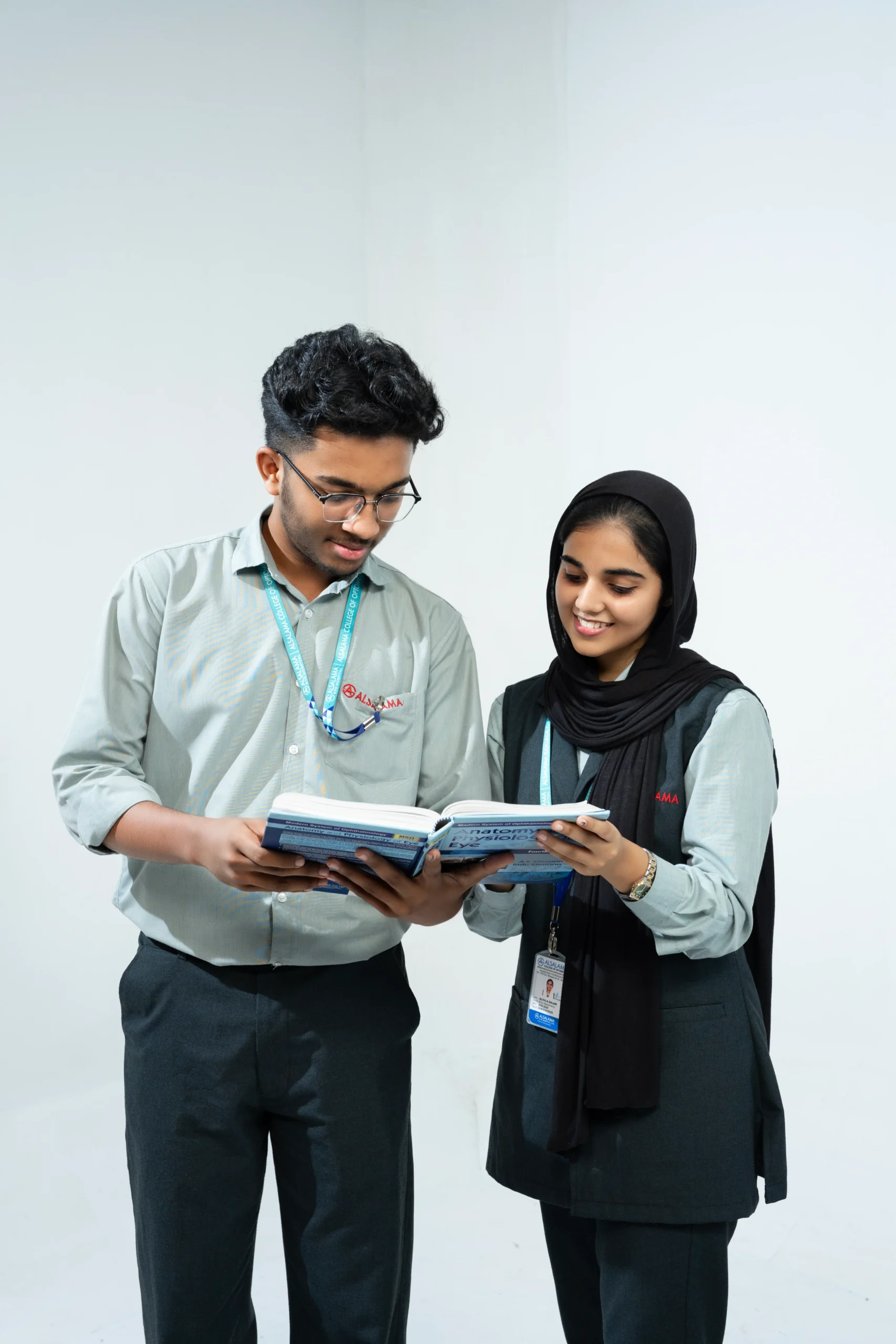 Male and female ophthalmology students studying together with a medical textbook, representing collaborative learning and academic growth